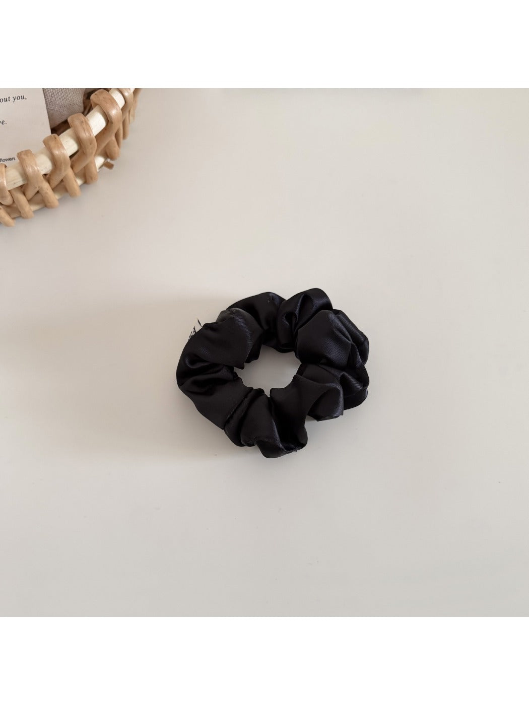 Satin bow scrunchie styled with a casual outfit and minimal makeup on a model