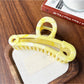 Beau gold paperclip claw clip displayed open to show spring hinge