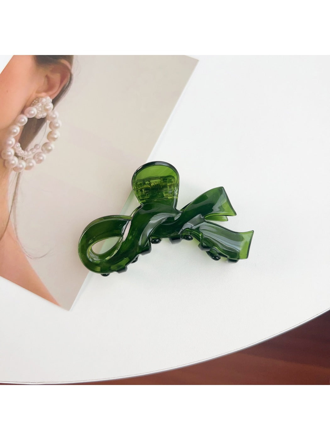 Beau delicate bow hair claw clip shown from angled perspective