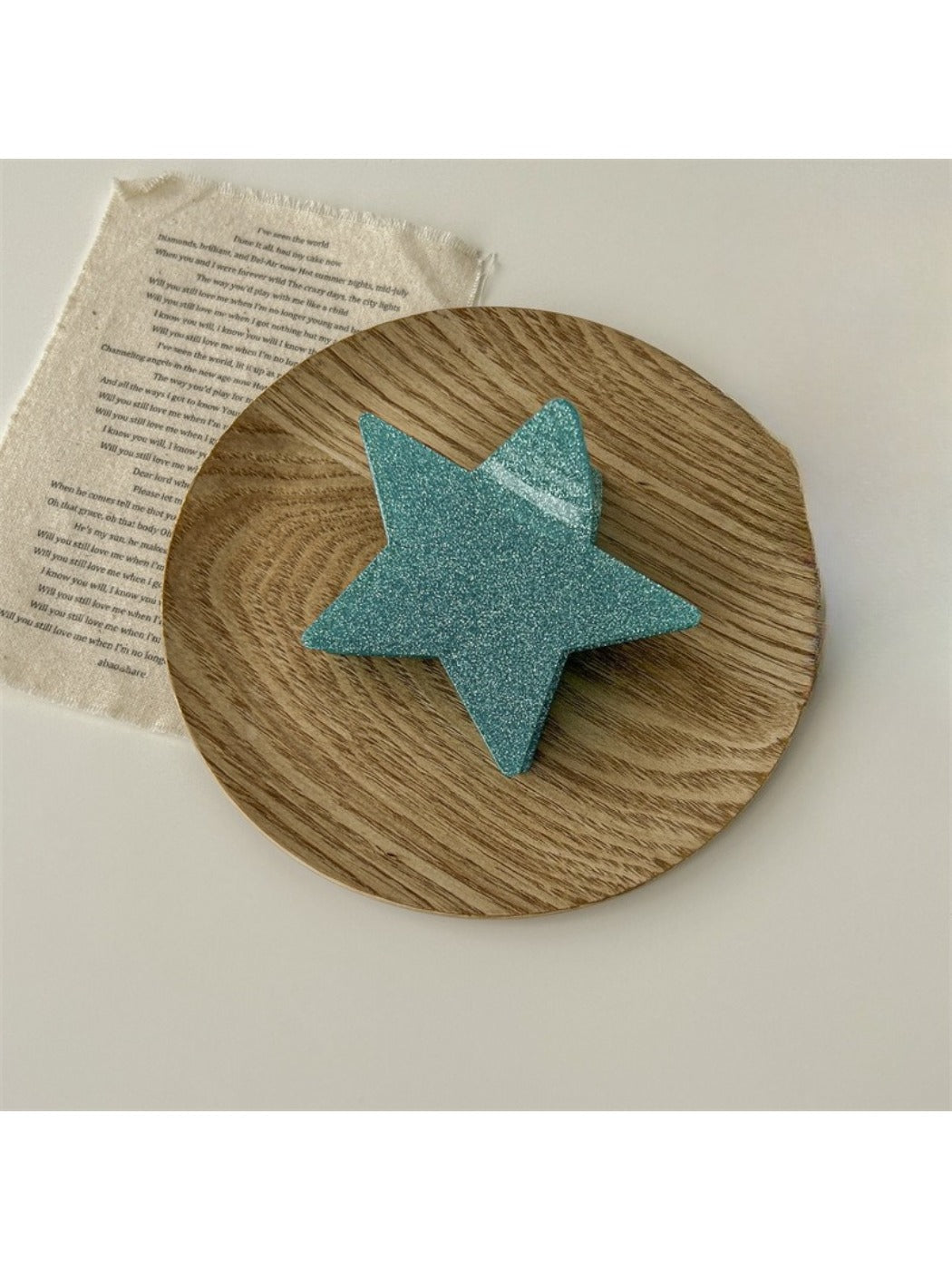 Beau star shaped claw clip positioned flat to show star shape outline