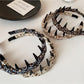Close-up of vintage floral pattern on fabric headband with muted colors