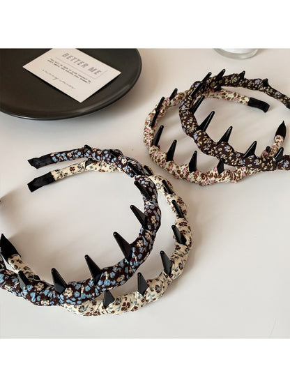Close-up of vintage floral pattern on fabric headband with muted colors