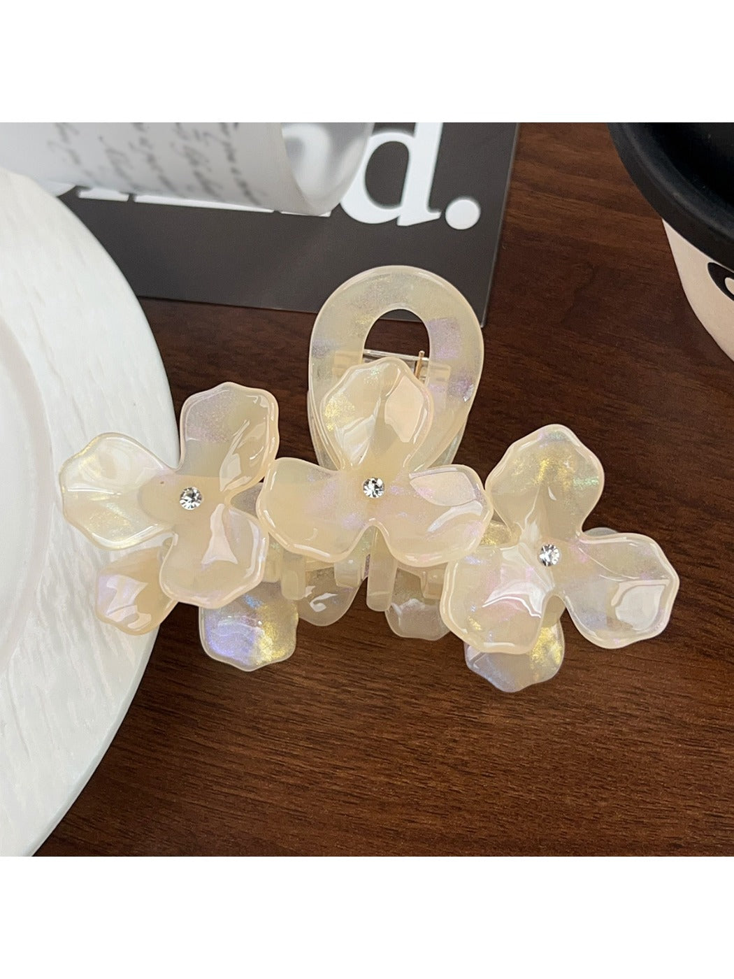 Beau hair claw clip positioned on a fabric background emphasizing texture and design