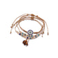 Detailed shot of tassel and small beads on Lovra alloy bracelet
