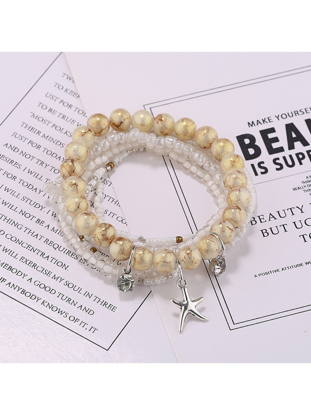 Side view of Lovra multi-row beaded bracelet highlighting star charm and bead details