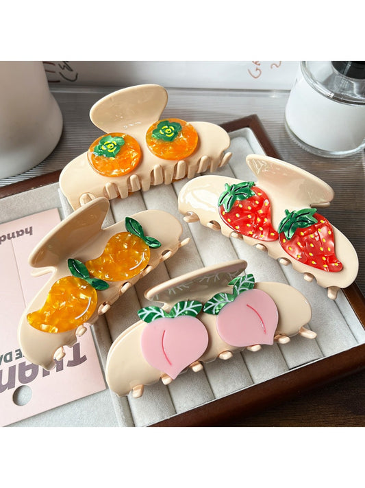 Beau cute fruit shaped claw clip in orange color on white background