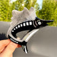 Beau cartoon sturgeon claw clip styled in hair on model