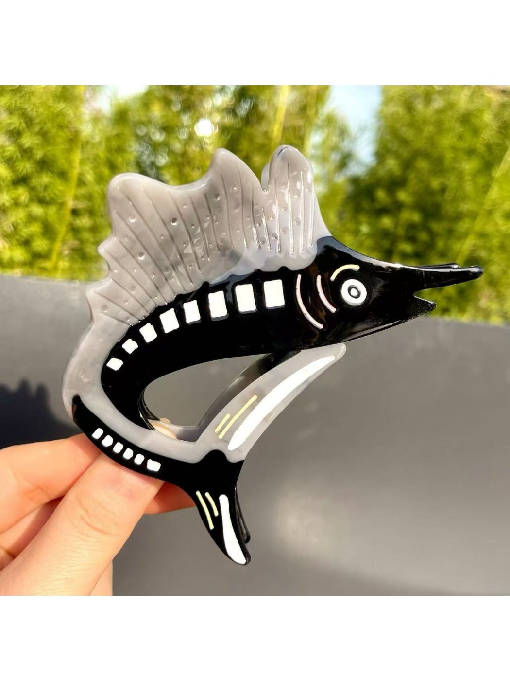 Beau cartoon sturgeon claw clip styled in hair on model