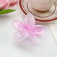 Beau classic colorful flower shaped claw clip isolated on plain white background