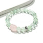 Lovra green fluorite bracelet displayed on a white surface showing bead texture