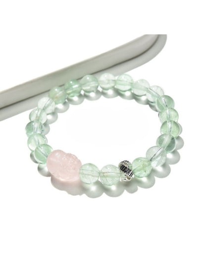 Lovra green fluorite bracelet displayed on a white surface showing bead texture