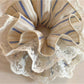 Gifty striped lace scrunchie styled on a wrist as a bracelet