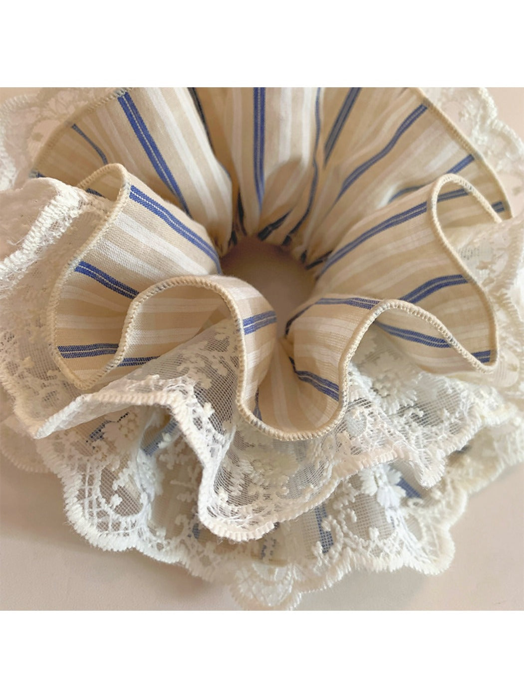 Gifty striped lace scrunchie styled on a wrist as a bracelet