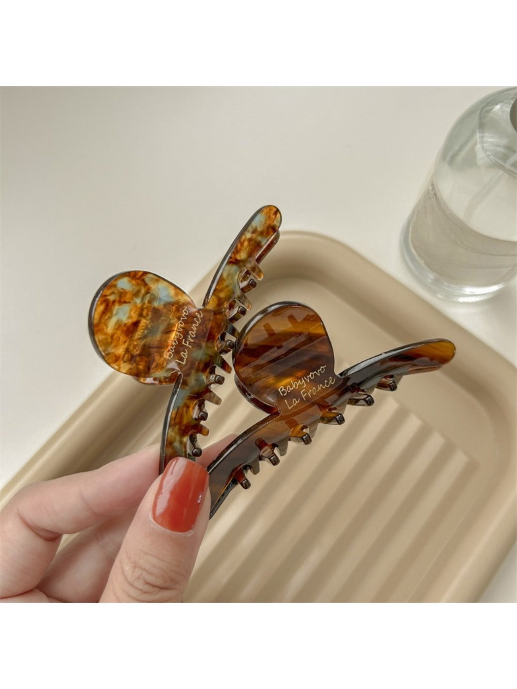 Beau brown acetate claw clip holding hair in a half-up hairstyle