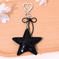 Gold star bag charm keychain displayed on a white background