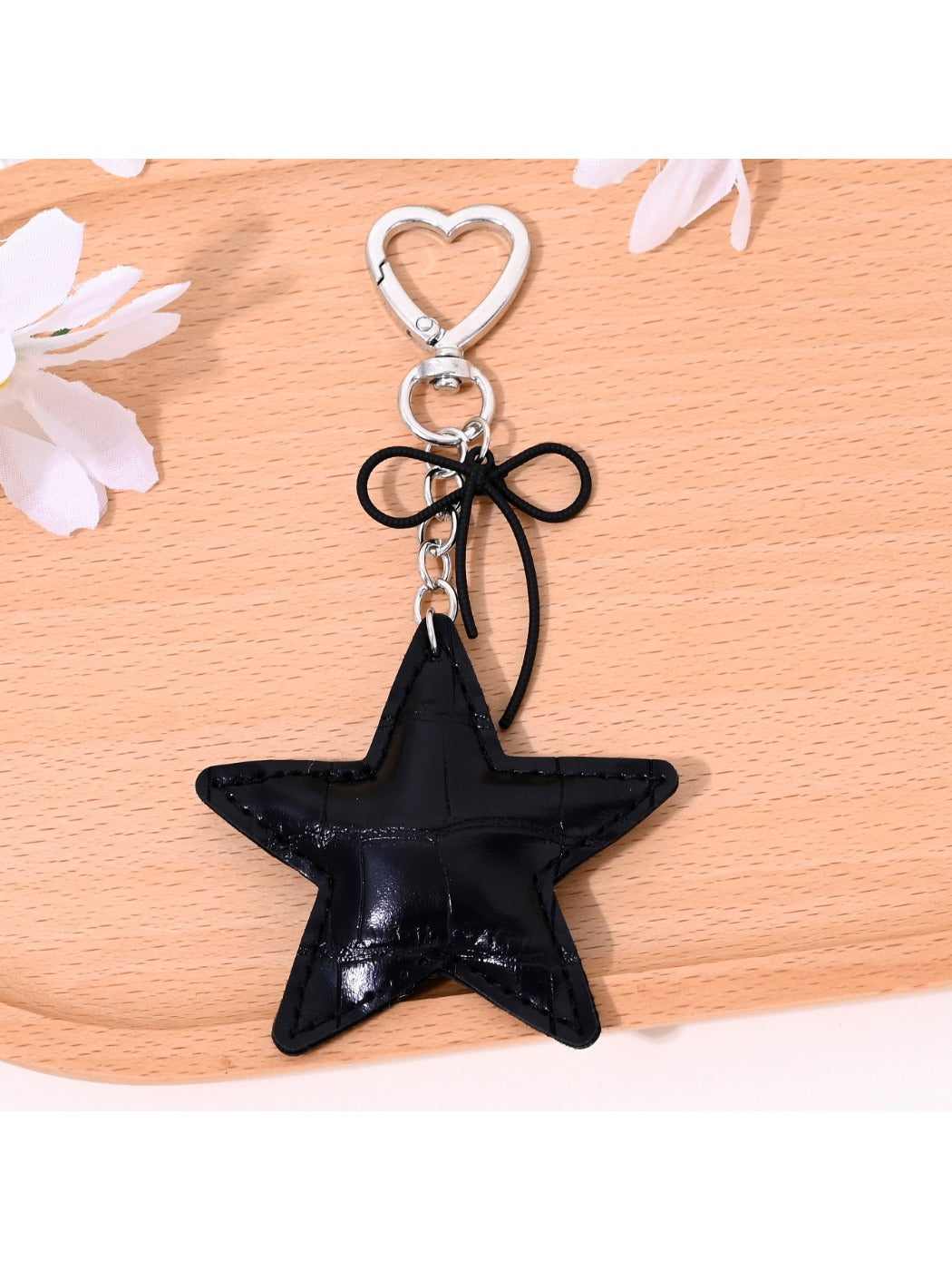 Gold star bag charm keychain displayed on a white background