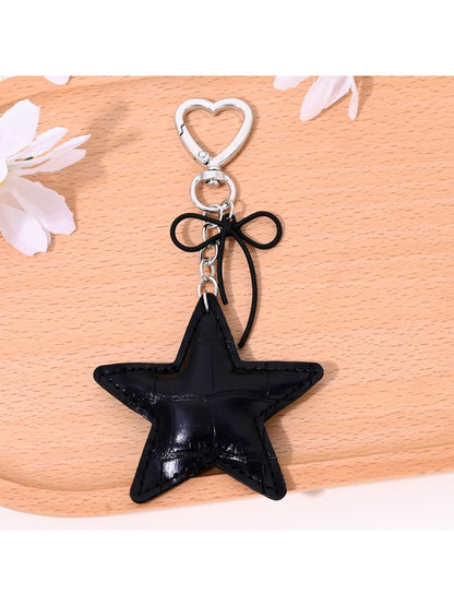 Gold star bag charm keychain displayed on a white background