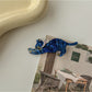 Beau hair clip featuring a smiling cat face with whiskers