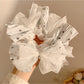 Gifty lace bow scrunchie with pink floral print on fabric
