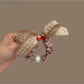 Close-up of Gifty Sweet Plaid Bow Scrunchie in red and white pattern