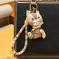 Hand holding vintage cat charm keychain showing size and detail