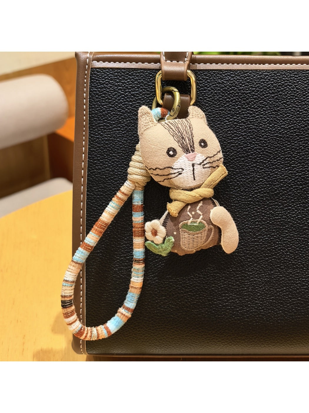 Hand holding vintage cat charm keychain showing size and detail