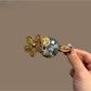 Beau hair clip with pastel floral pattern and gold-tone metal clip base