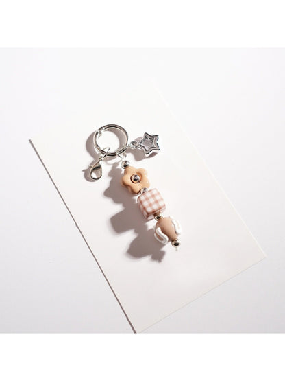 Side angle of the colorful beaded star keychain highlighting bead texture