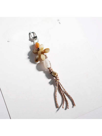 Keypus acrylic beaded flower keychain shown with a blurred background