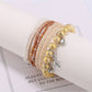 Lovra star pendant bracelet styled with casual outfit on model's wrist