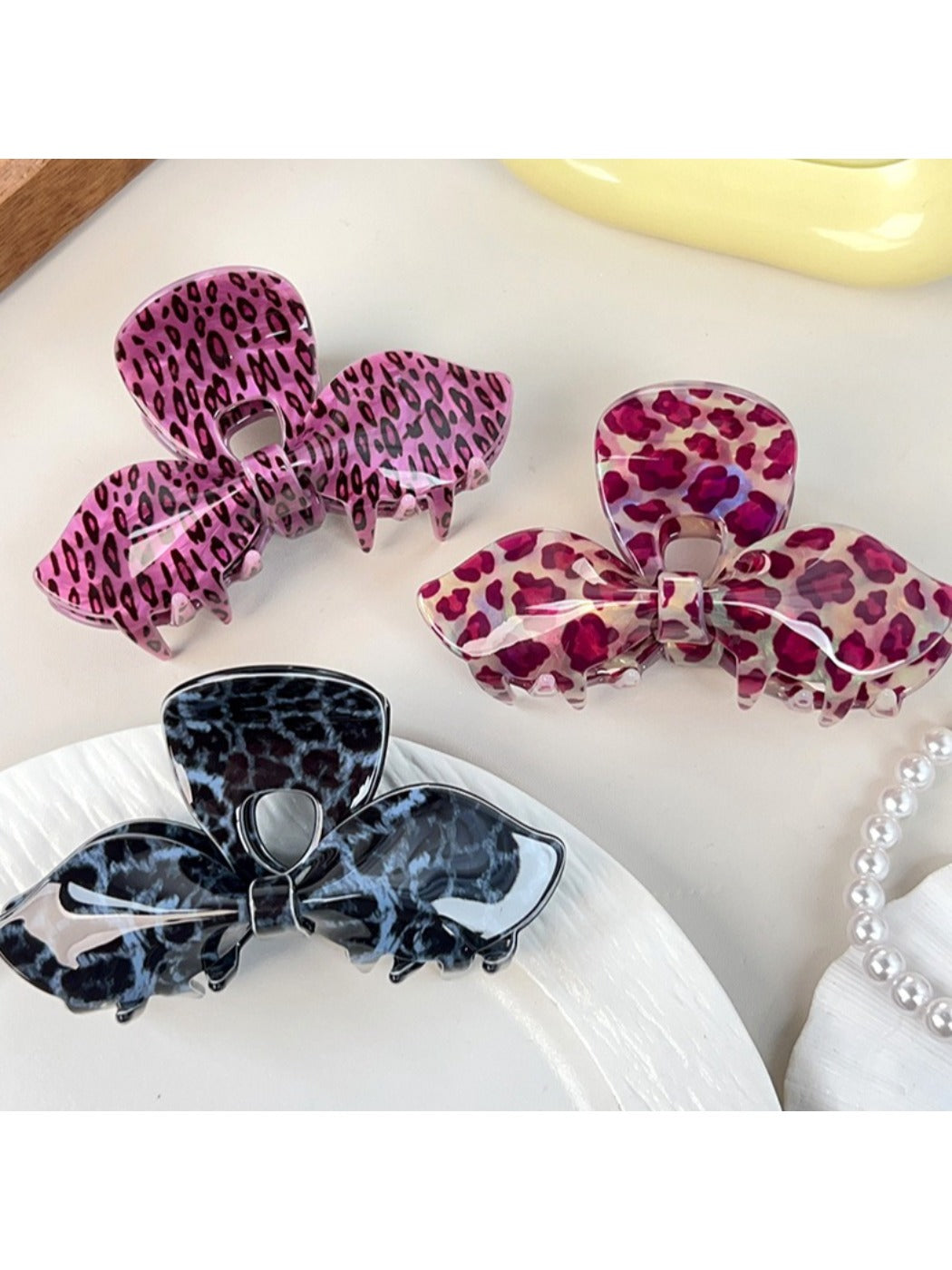 Side view of Beau leopard print bow hair claw clip