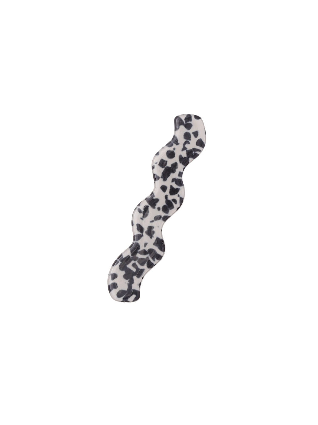 Beau hair clip positioned on wooden surface showing shape and size