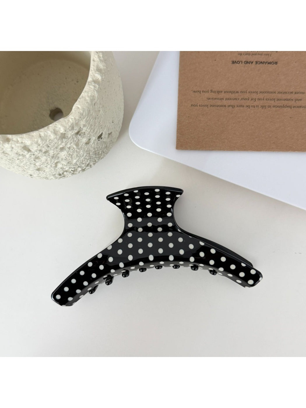 Close-up of Beau acetate hair clip showing smooth glossy finish and polka dots