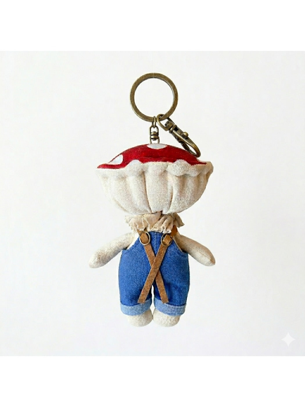 Keypus fabric doll keychain displayed on a wooden surface with soft lighting