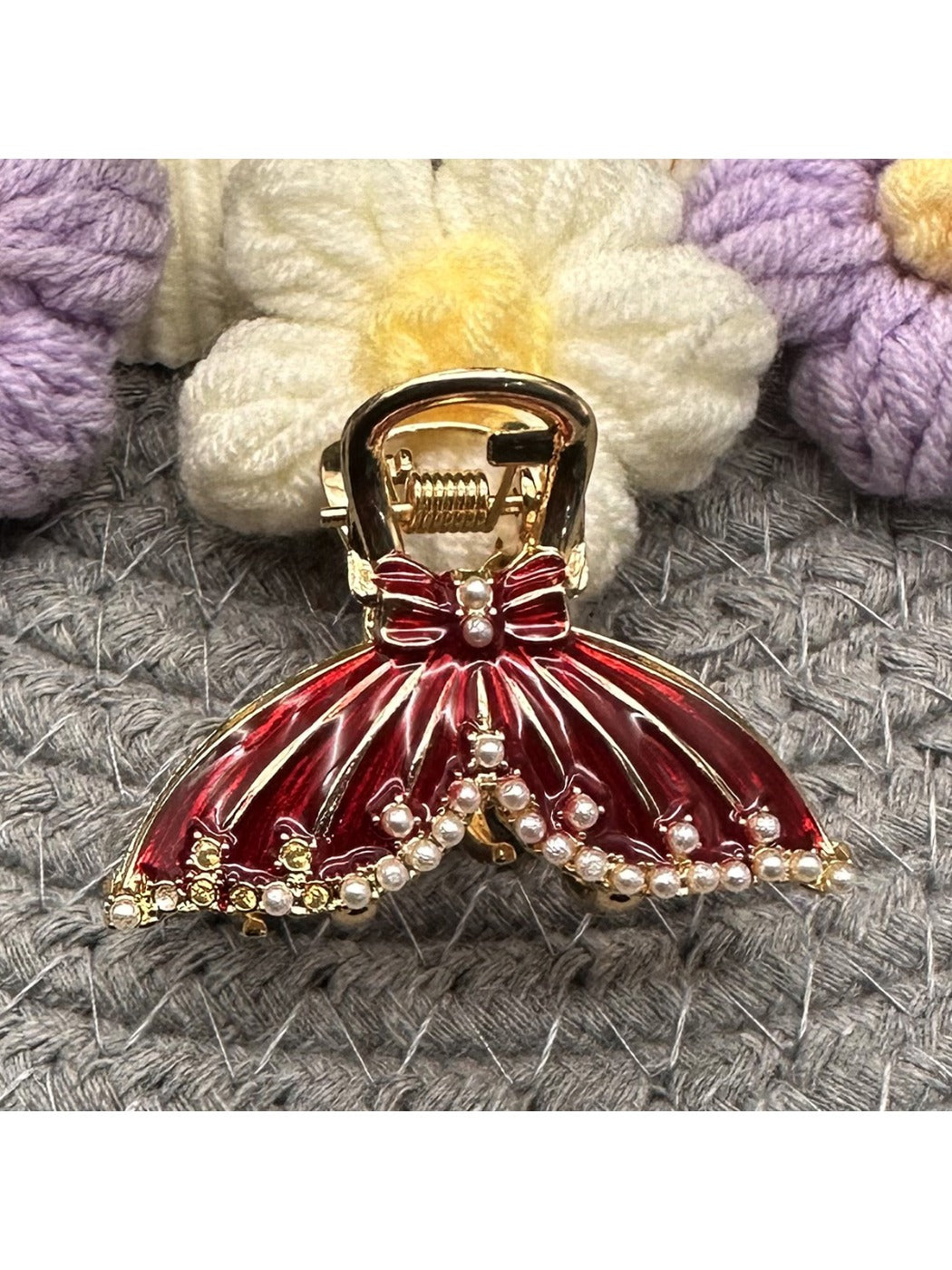 Close-up of gold-tone butterfly hair clip showing detailed filigree wings