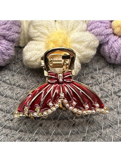Close-up of gold-tone butterfly hair clip showing detailed filigree wings
