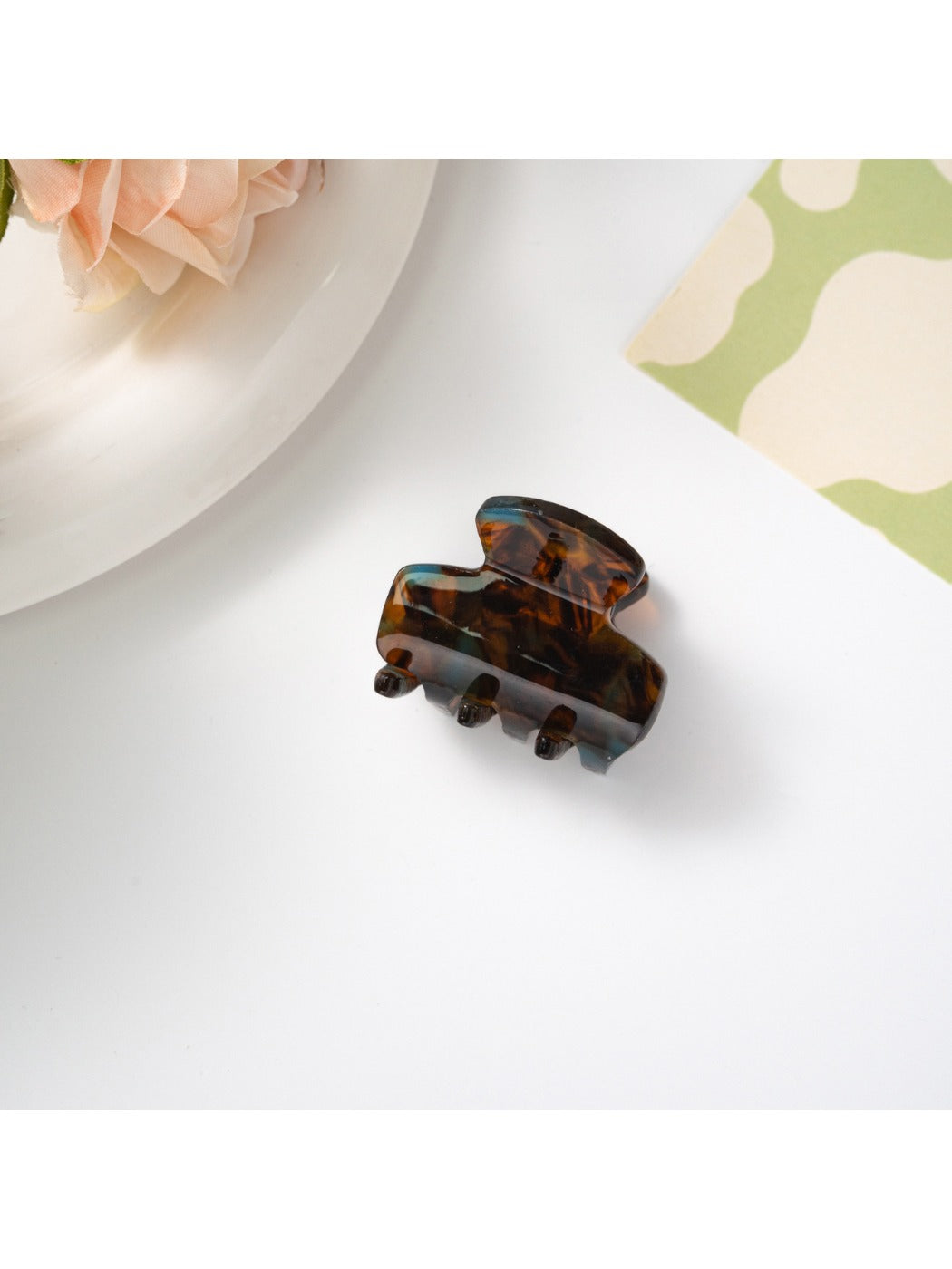 Beau hair clip styled in model's hair showcasing elegant retro pattern