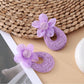 Sweet Raffia Flower Shaped Stud Earrings displayed with green leaves background