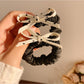 Close-up of the polka dot bow detail on the vintage style hair tie