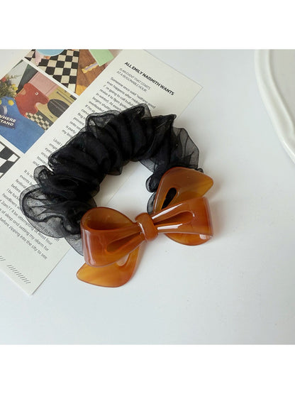 Gifty scrunchie styled in a ponytail with mesh bow accent