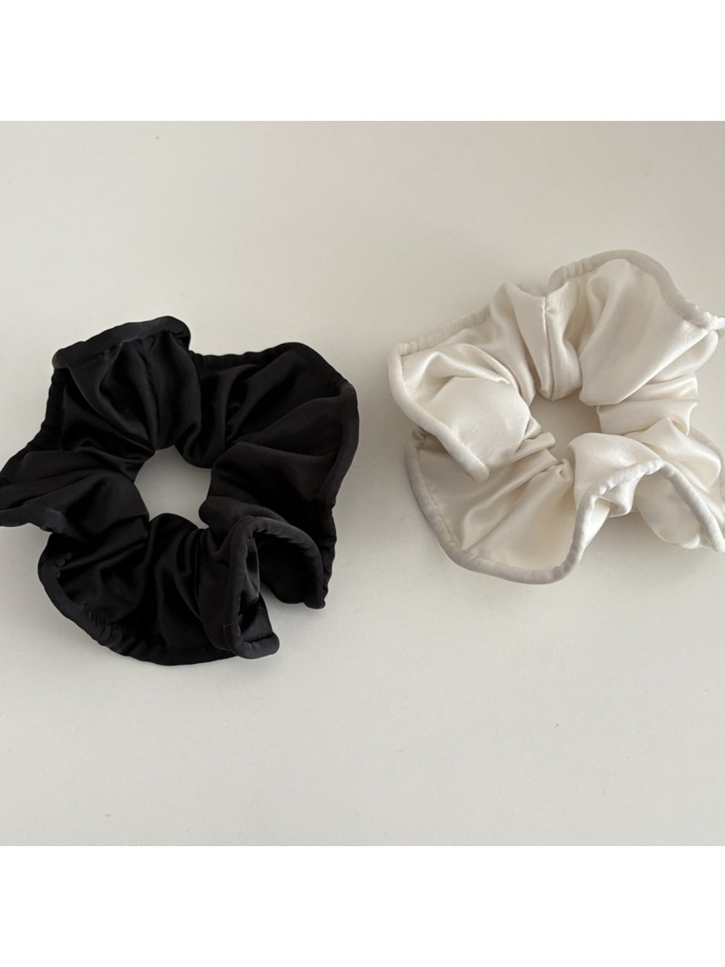 Gifty satin finish scrunchie wrapped around a ponytail on a model