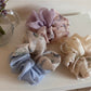 Gifty scrunchie styled on a wrist with soft gradient colors