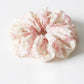 Multiple Gifty printed ruched scrunchies stacked to show pattern variety