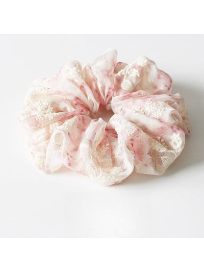 Multiple Gifty printed ruched scrunchies stacked to show pattern variety