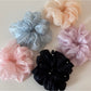 Gifty scrunchie styled in a ponytail on a model with casual outfit