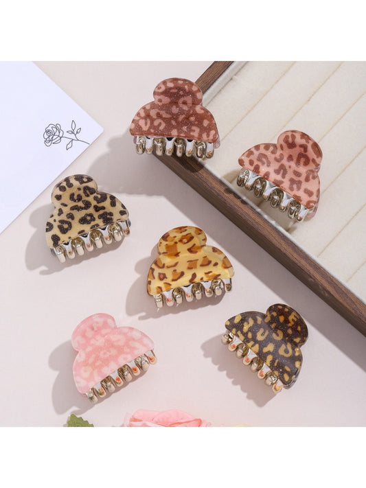 Close-up of Beau leopard print hair clip with gold-tone clasp on white background