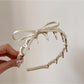 Close-up of bow knot detail on the pink headband