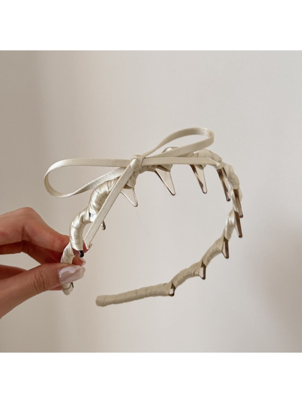Close-up of bow knot detail on the pink headband