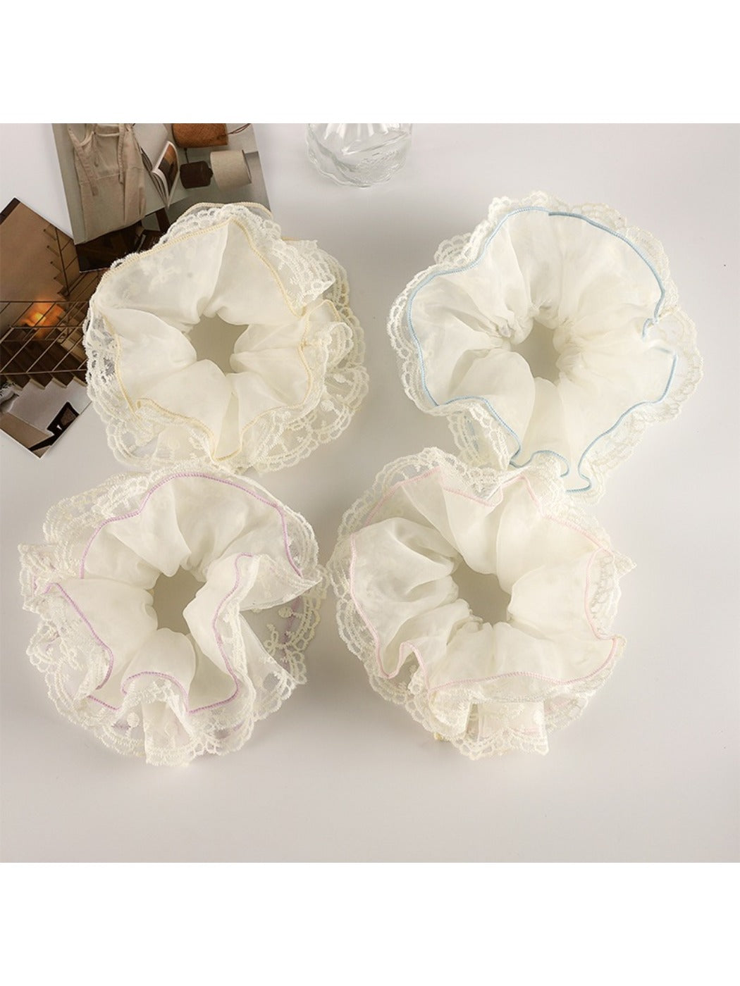 Close-up of Gifty double layer scrunchie in soft pastel pink fabric