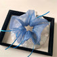 Gifty plaid hair scrunchie styled on a ponytail with visible double layers